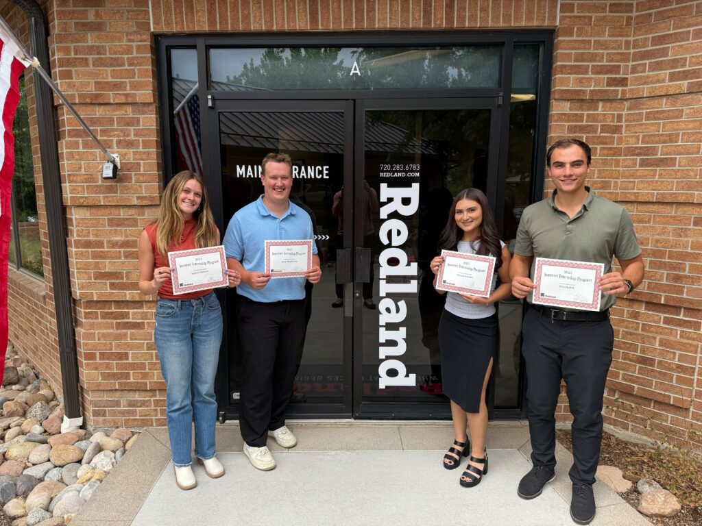 Redland interns displaying their certificates of achievement.